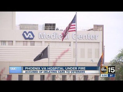 A hospital with an american flag flying in front of it.