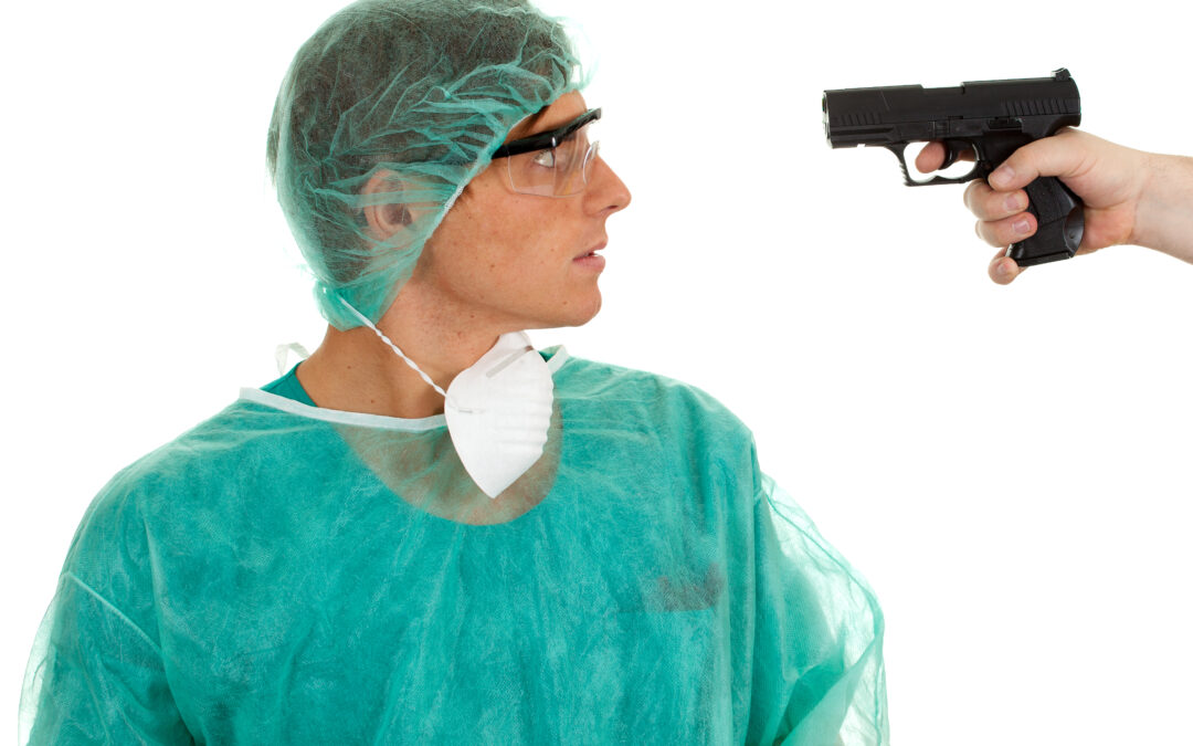 A doctor wearing a full body cover being pointed with a gun